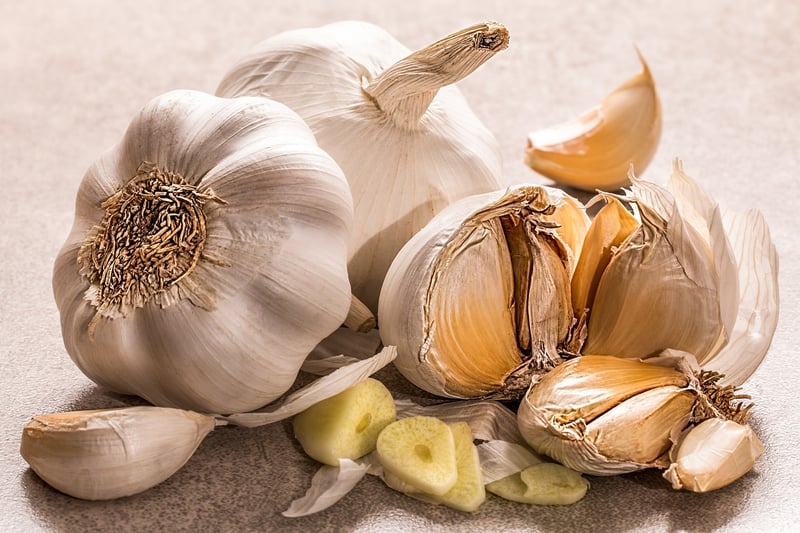 Garlic and herbs on a cutting board